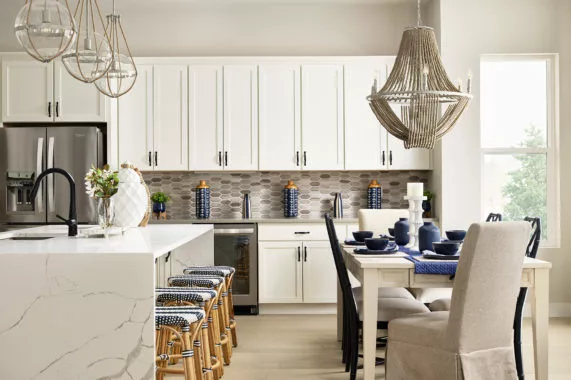 Dining room with kitchen, white cabinets, and blue accents