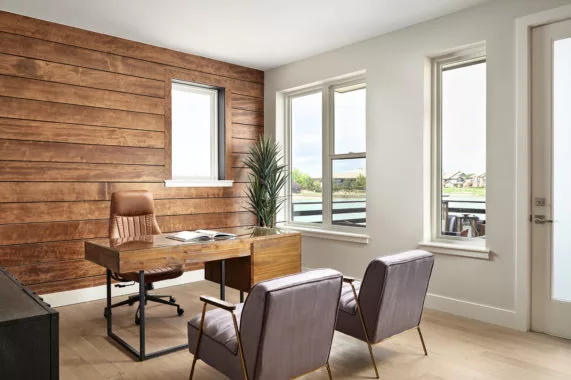 Modern office with wooden accent wall and large windows