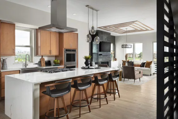 Modern kitchen and living room with island and barstools
