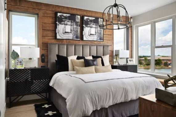 Modern bedroom features a large bed and decorative elements