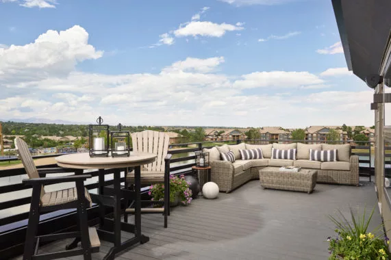Rooftop patio with seating, table, and scenic view