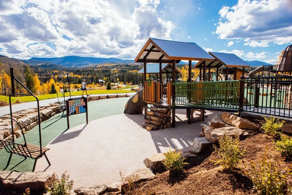 Idlewild Park children's playground against scenic mountain backdrop 