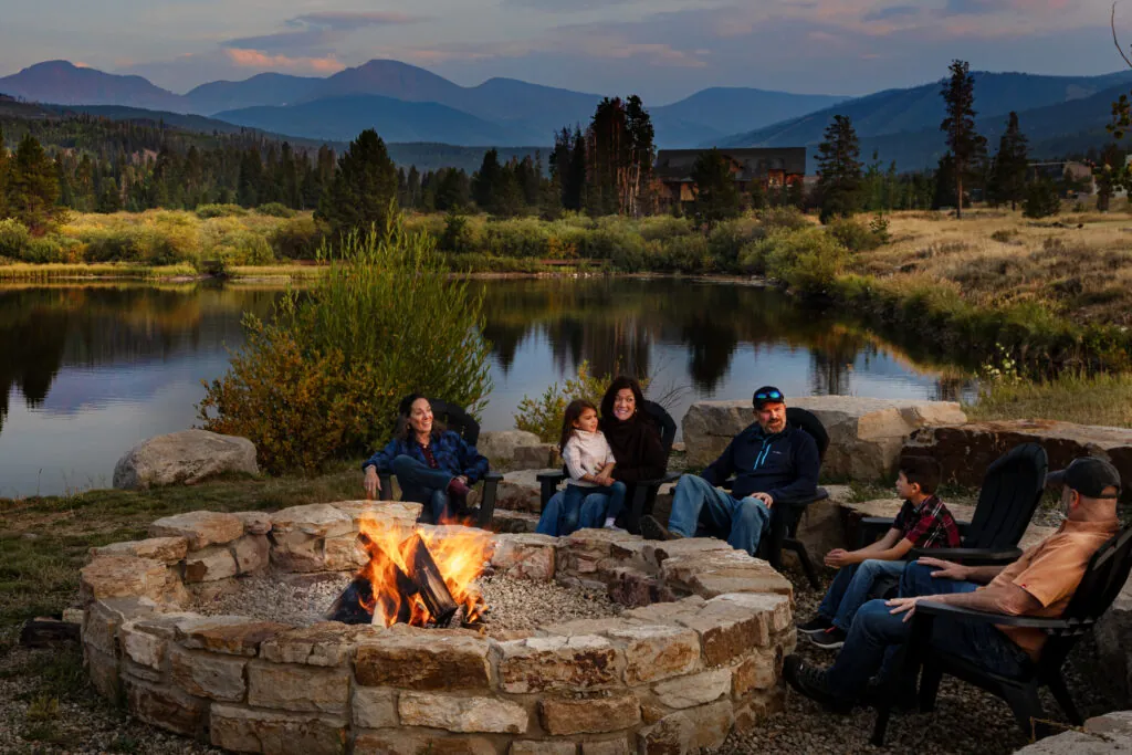 Family around firepit at Rendezvous